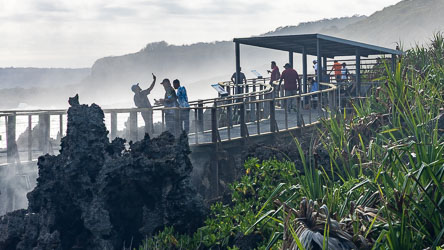 At the Blowholes, rugged pinnacles of limestone are viewed by visitors on the boardwalk. [9894]