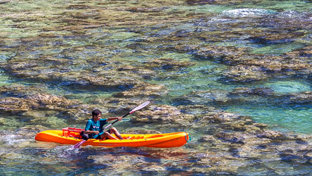 It looks like this young lad is setting out across the crystal waters of Flying Fish Bay in the hope of catching dinner. [9878]