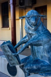 Sheep reading 'The Power Of One' is part of a the `Mrs McGrath Returns` sculpture by John Wood. Mrs McGrath used a pet sheep to lead large mobs across the Hay bridge in 1920-30s. [5052]