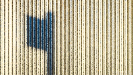Seen in Hay, this wall made of galvanized ripple iron. [5054]