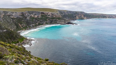 Weirs Cove, where steep cliffs lead down to a beach with crystal clear waters. [3729]