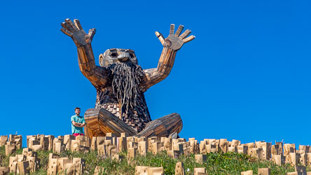 Theme: The Sun and the Ocean. Santi Ikto is a tall giant often found sitting cross-legged, overlooking the ocean with his arms reaching towards the sky. His story is that he is asking the sun to evaporate the seawater to create the rain clouds, starting the vital water cycle. [9607]