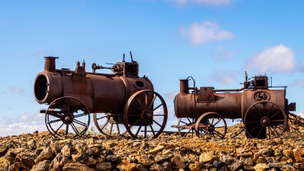 Steam engines on display at the Day Dream Mine. Signage said these were made in England, shipped to Adelaide, and walked to the site by bullock teamsters. They were used as mobile pumpjack motors. [2969]