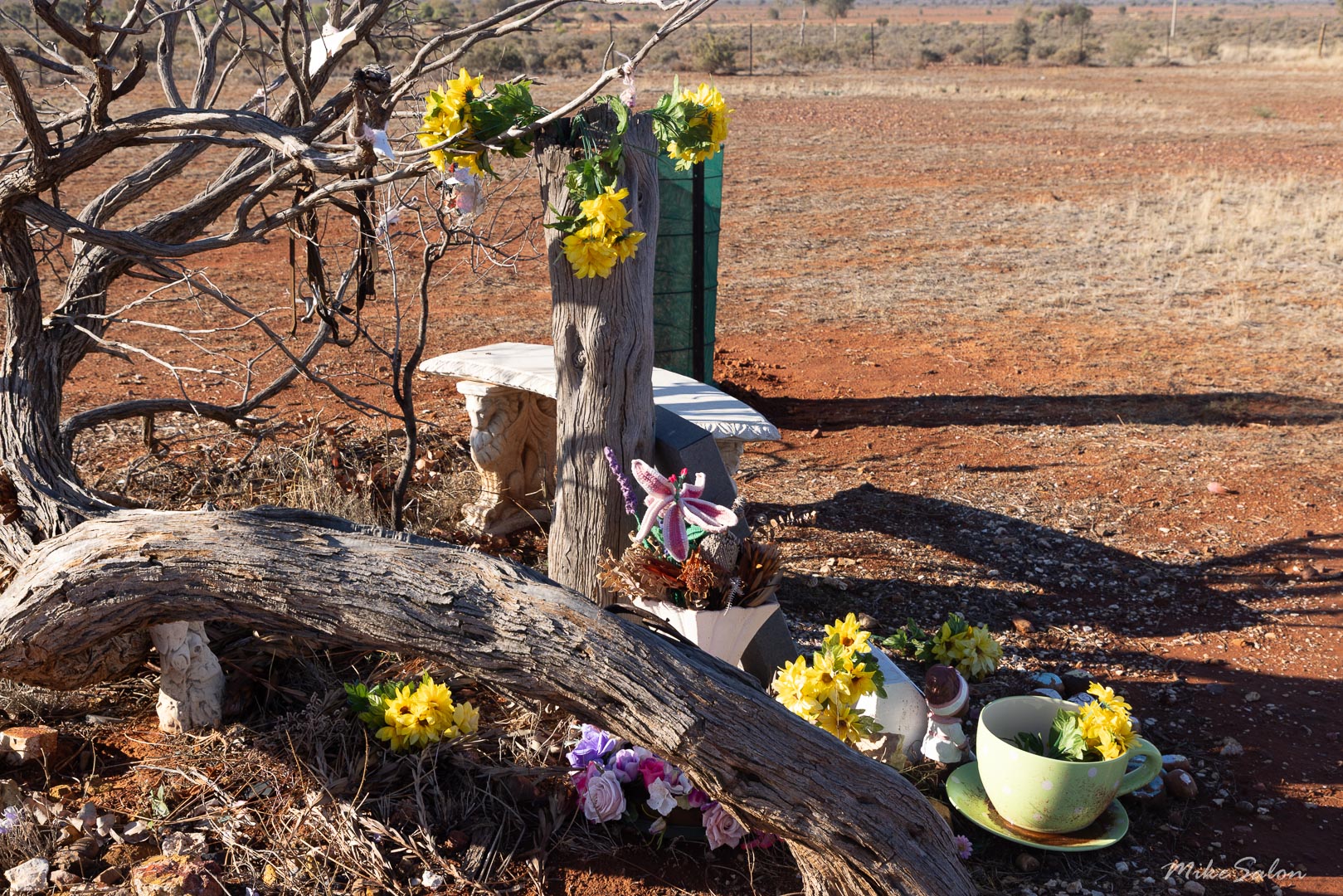 The newest grave in the cemetery was freshly decorated in a rustic style. [2113]