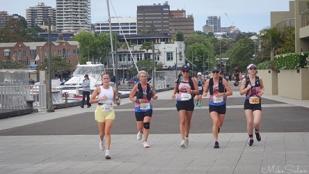 A group of Bondi‑to‑Manly Ultra runners on the west side of Woolloomooloo Bay section, passing the marina and waterfront apartments. The 80 km course winds through Sydney’s most scenic harbourside precincts, blending endurance with the city’s maritime charm. [4751]